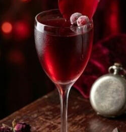 [ Immortal Kiss ] White Vermouth, stained with raspberries and cranberries, blended with sparkling wine which is chilled to the touch. Sensually served in a wine goblet and rose petal from Merovic's poison garden. (/roll 20 to see if poisoned.)