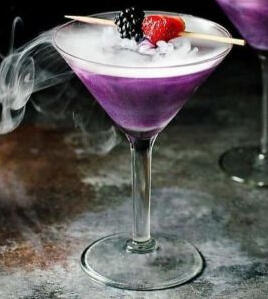 [ The Witch's Heart ] Purple Blackberry Vodka, Sour Apple Liqour, Lemon, Grenadine, and a sprinkle of ashes dust with a final touch of berries in a chilled glass. **Organically direct from the Witch.