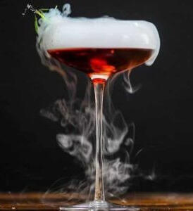 [ Mourning Bitters ] Dry Rye Reposado Gin, the hearts of artichokes--Cynar, and Strawberry Campari finished with Coerthan dry ice and a sprig of herbs caught on fire in a flute. Sourced from the local Witch's Garden.